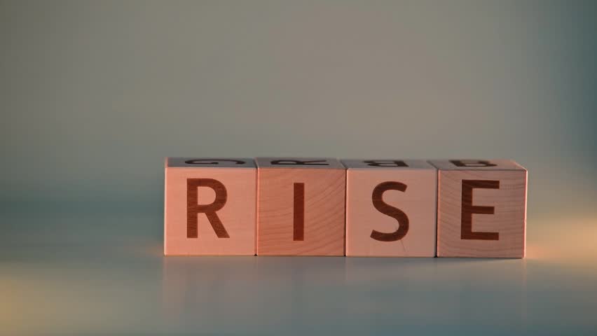 Blocks with letters are placed on a table and a hand is seen moving them to form two different words. The action takes place in a suitable indoor setting, highlighting the transformation of the words.