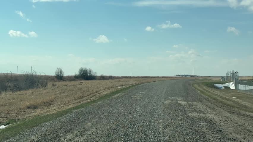 Driving Down a Gravel Road Point of View in Rural Countryside