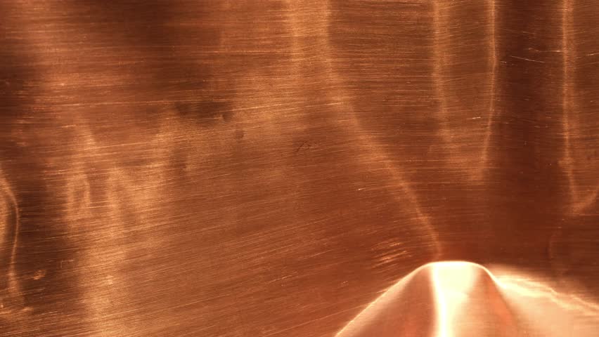 Abstract copper metallic background with warm bronze tones. Sunlight, copper, and shadow. Design backgrounds. Minimal. Selective focus.