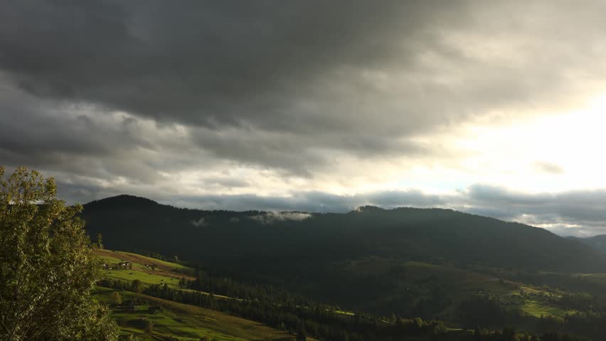 The Carpathian Mountains in Ukraine during a time lapse. The light changes as clouds move, revealing rolling hills and lush greenery throughout the day.