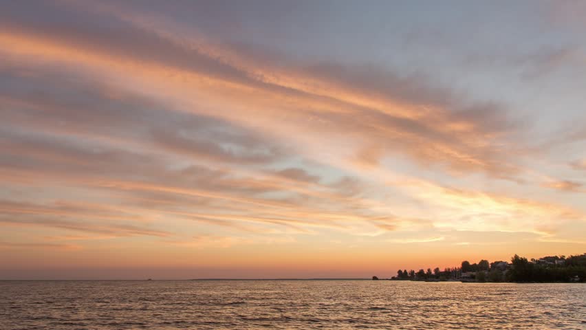 Sunset timelapse with river view, sunset and clouds near the river beach