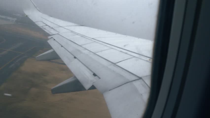 Airplane taking off into clouds wing view
