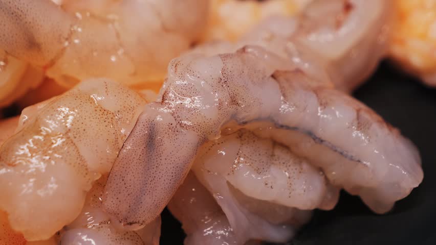 A close-up of large, raw, peeled shrimp, a source of high-quality protein. High quality 4k footage