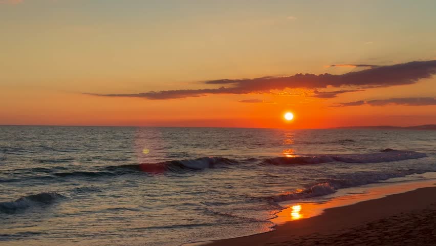 Golden sunset over ocean horizon showing calm natural seascape and open sky