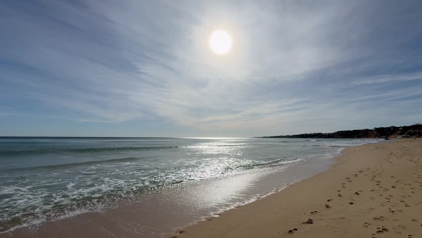 Bare footprints in the sand on a beach