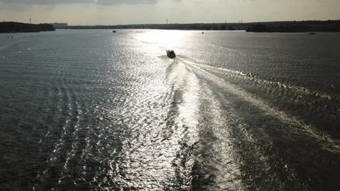 Drone Tracking Sailboat across Bright River Water