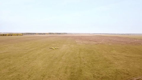 Drone Following Small Airplane Taking Off at Oreshkovo Airfield in Autumn