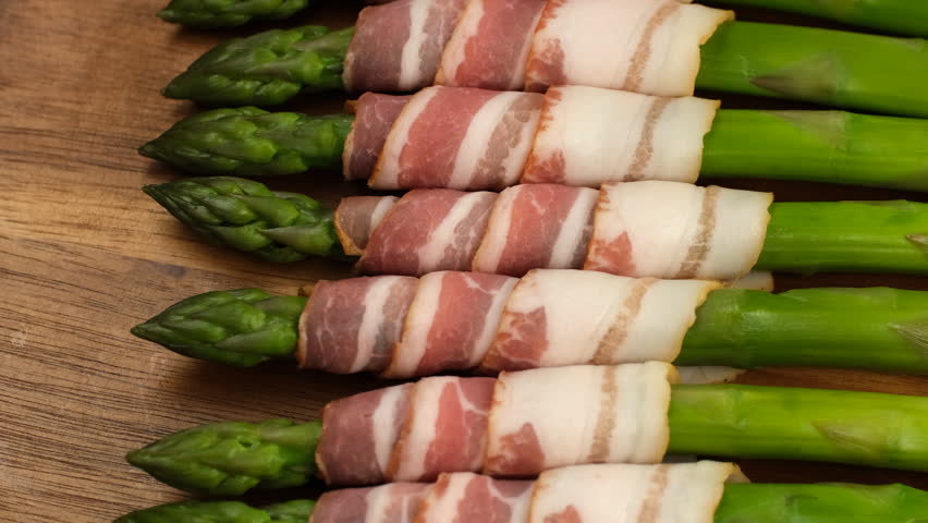 Delicious Bacon wrapped asparagus ready for cooking, rotation