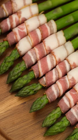 Asparagus recipe. Bacon wrapped asparagus ready for cooking, rotation