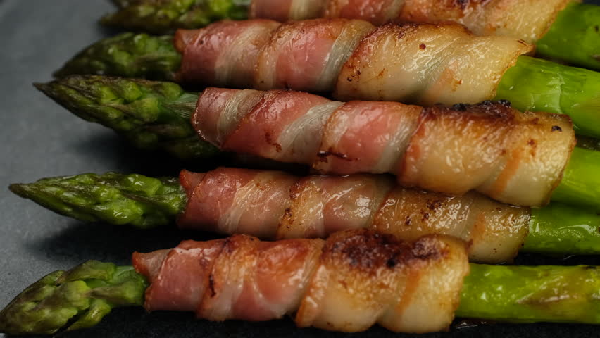 Cooked Fried Bacon wrapped asparagus, rotation