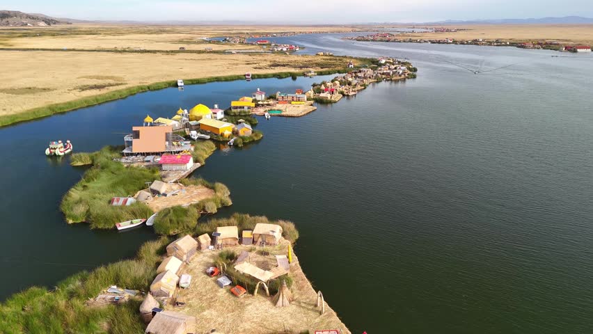 Aerial drone view of the floating Uros Islands on Lake Titicaca. The highest navigable lake in the world, located near Puno, Peru, South America. Popular travel destination.	
