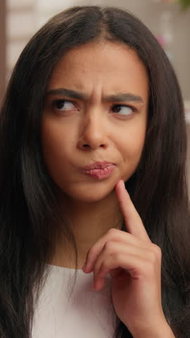 Portrait hesitate pensive Hispanic girl Latina woman thinking confused solving searching decision American ethnic female think hesitant pondering deciding skin care routine in pink candy bathroom