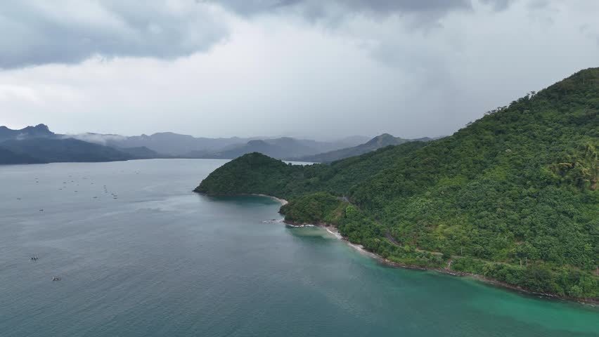 Aerial View of a Serene Tropical Bay with Lush Green Islands Under Dramatic Cloudy Skies