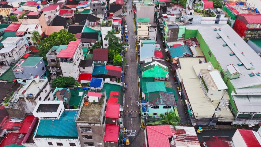 Aerial view shows compact urban neighborhood and daily life in Manila city