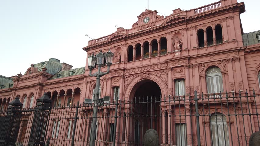 The iconic pink facade of Casa Rosada, the executive mansion and office of the President of Argentina. Establishing shot of this historic landmark located in Plaza de Mayo, Buenos Aires