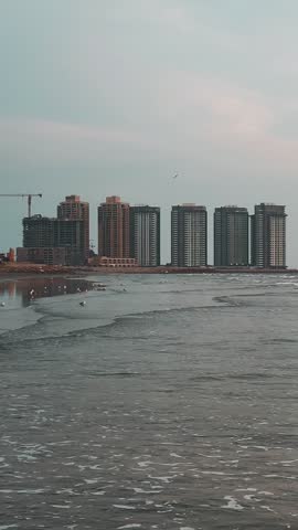 Beautiful skyline along with sea, Karachi, Pakistan and beautiful wave formation and birds flying around.