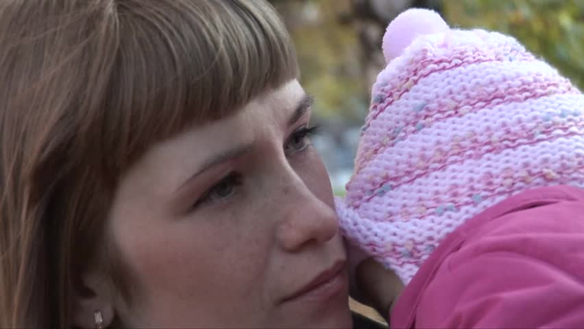 Mum holds a daughter on hands, she sleeps