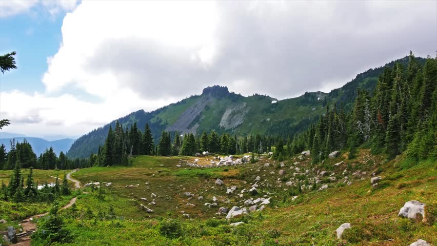 footage captures the lush alpine meadows and rugged mountain peaks along the popular Spray Park Trail in Mount Rainier National Park, Washington State.