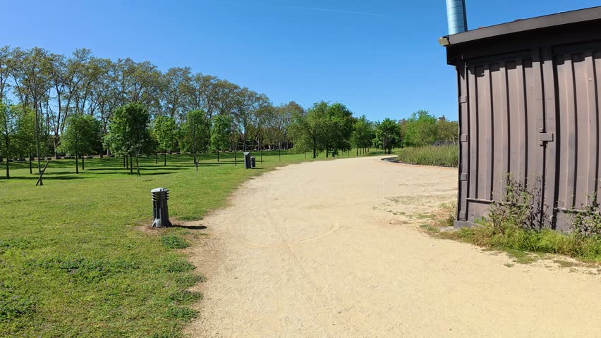 dirt road leading to the lake in the central park of Santa Perpetua, Barcelona