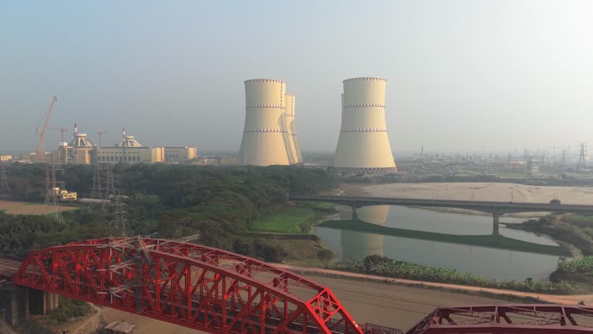 Power plant with cooling towers beside a river