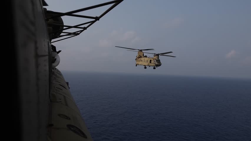 Two CH-47 Chinook helicopters flew across the conflict-ridden sea.