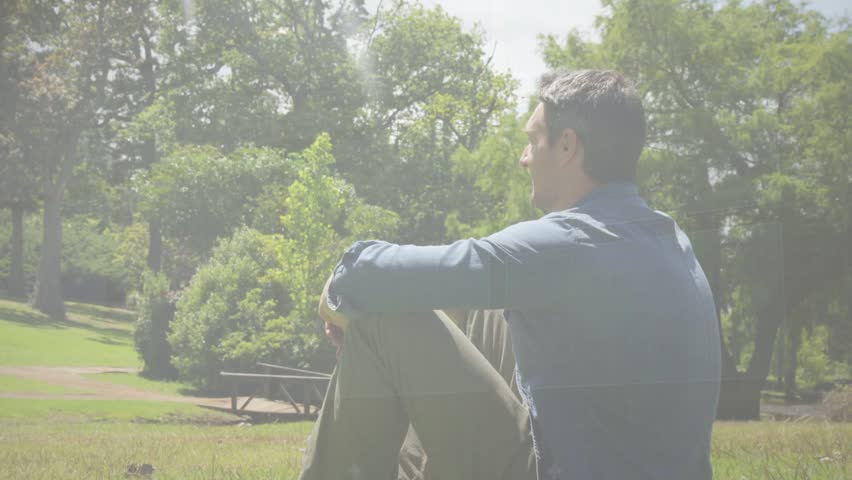 Family boy climbing onto dad sparking play wrestling, dad lifting, ring overlay hovering in park. Outdoor, nature, grass, trees, bench, caregiver, bonding