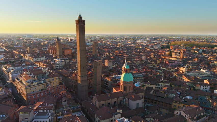Drone captures ancient skyline Bologna. Aerial perspective showcasing medieval towers and rooftops at dusk