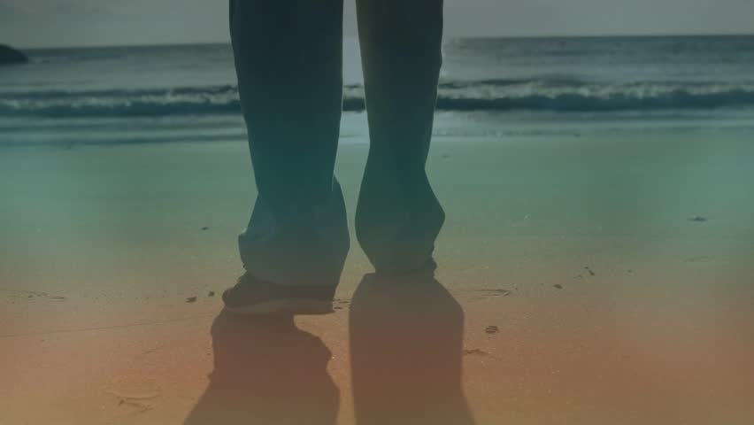 Senior man walking on wet sand, stepping toward surf while animated footprints marking travel range. Beach, seascape, backlit, serene, elderly, casual, waves