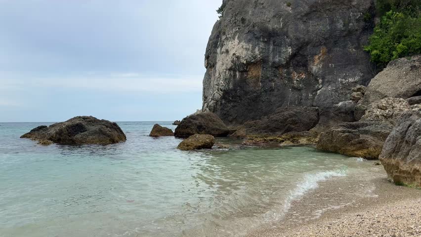 Amazing landscape with calm sea and big rocks on the beach