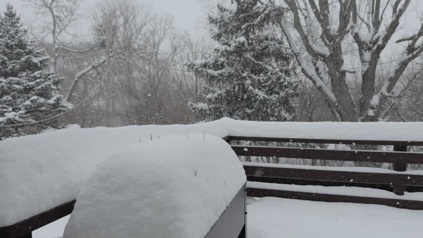 Large amount of snow landing on back patio during storm 4k
