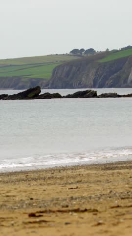 Calm deserted beach on a cloudy day