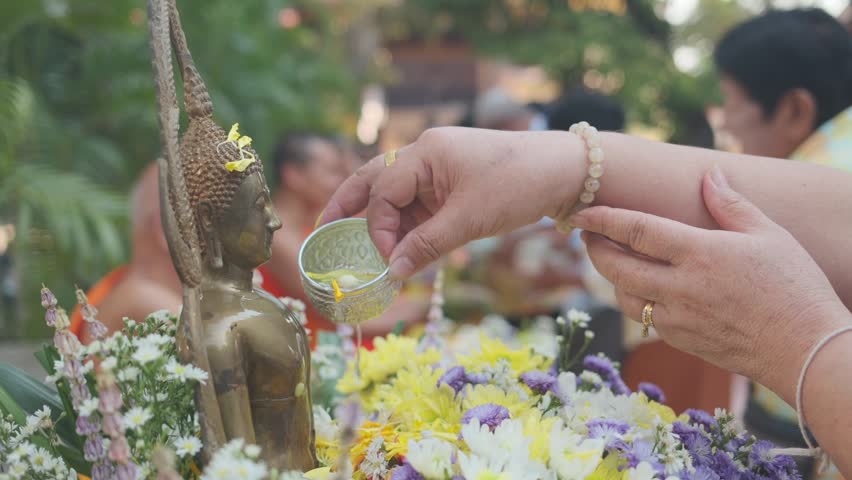 Shower the monk sculpture with Songkran festival Thailand