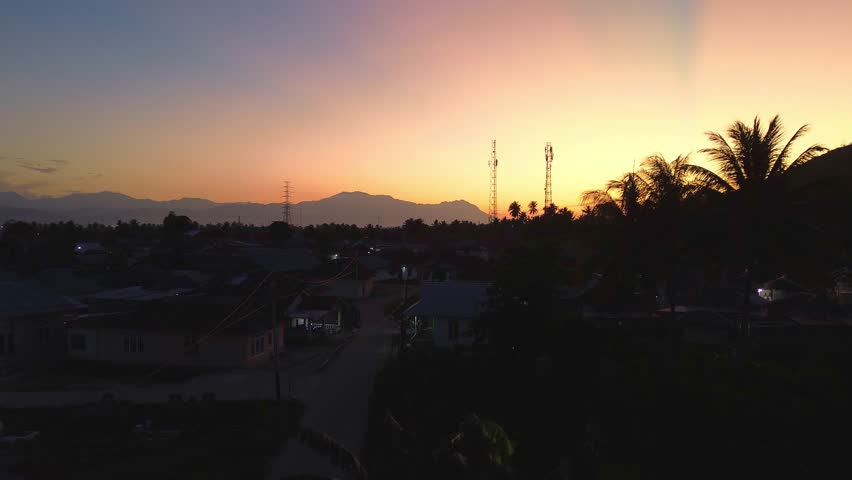 Scenic Sunrise Over Cityscape and Mountains