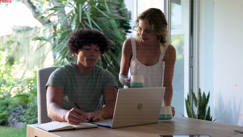 Seated man tapping pen, activating waves overlaying table while woman pointing at laptop designing. Collaboration, notebook, sunlit, backyard, plants, casual, homeoffice