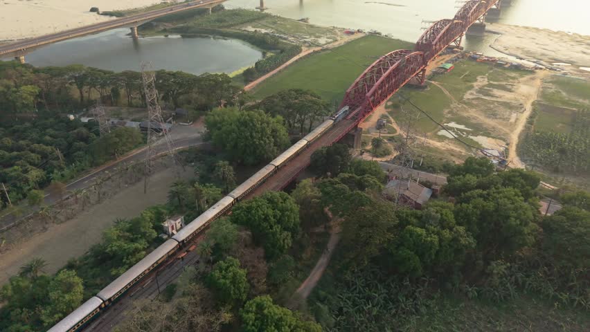 Red bridge over green landscape and river