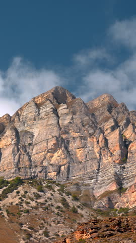 Sunlit Mountain Scene, Bright Sunlight Casting Shadows Over Rugged Mountain Terrain. Creative