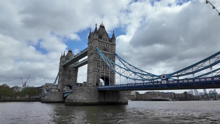Famous tower bridge stands over the river thames in london, a symbol of british heritage and business, with the city