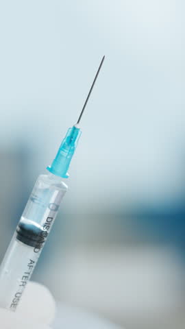 Doctor, needle or injection with hands or liquid for cure, vaccination or antibiotic in hospital. Person, drip and syringe with medical fluid for healthcare vaccine, medication or flu shot in clinic
