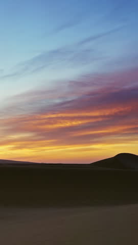 Beatiful landscape in Sahara desert at sunrise, zoom out timelapse. Vertical video