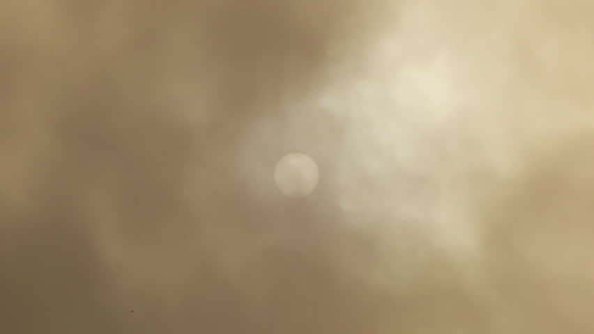 Sun with clouds of calima or kalima