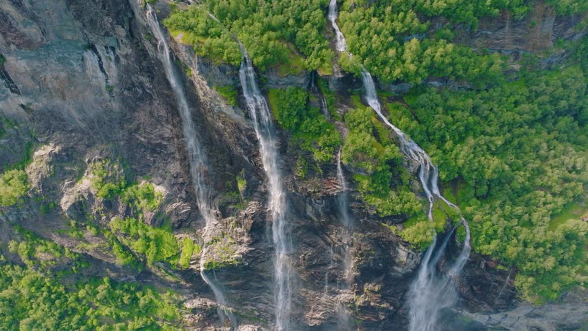 Seven Sisters Waterfall, Geiranger Fjord, Norway. Nature in fjords. Traveling through the Norwegian fjords. Scandinavia. View of nature from the drone. Vacation and travel in summer Norway.