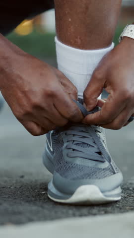 Person, hands and tying with shoes on road for fitness, workout preparation or outdoor exercise. Closeup, active or runner ready with sneakers, laces or tie for cardio training, walk or sprint