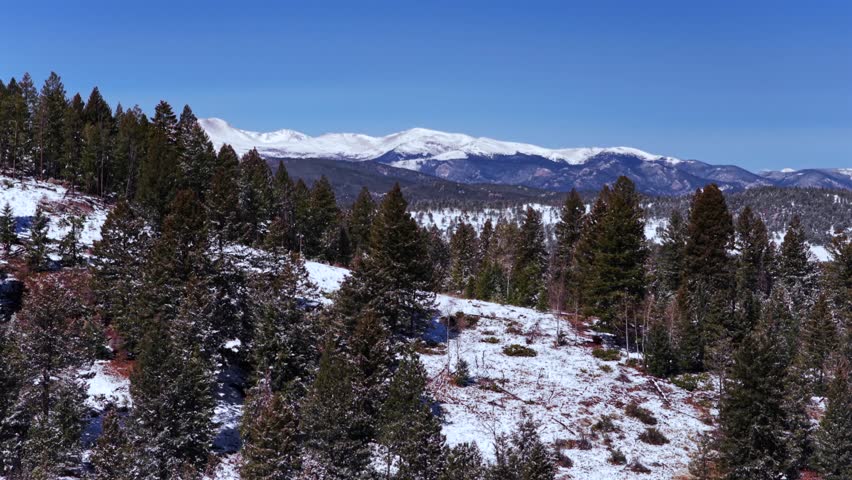 Blue Sky Mountain Snow-covered Peaks Evergreen Mount Blue Sky Front Range Rocky Mountains Colorado aerial drone spring snowy trees dense forest sunny morning clear skies Mt Evans circle right motion