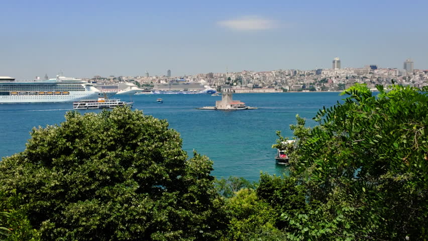 Istanbul, Turkey. A large white cruise liner navigates the Bosphorus Strait past the Maiden