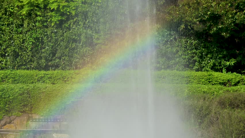 Rainbow appears over the park fountain.