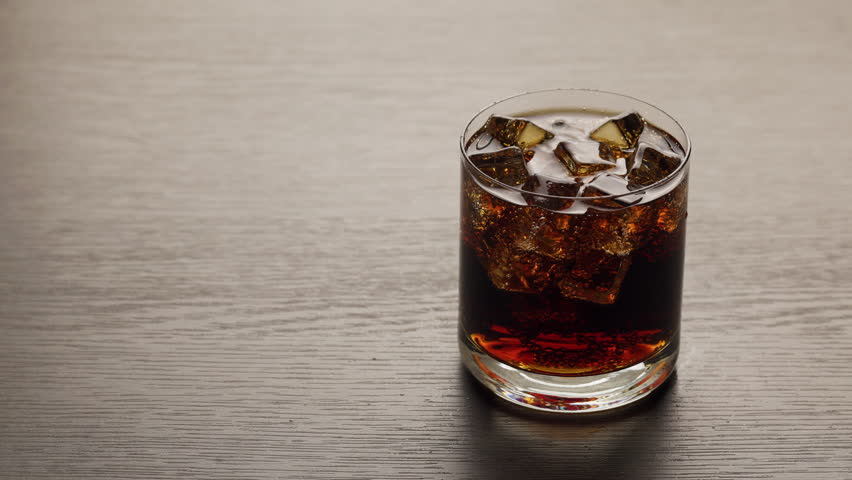 Video of cold cola with ice cubes in 4K