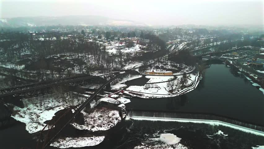 Aerial view over winter river and snowy island in Easton Pennsylvania