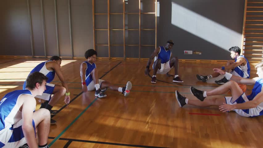 Overlay appearing and drawing court map over basketball team, pulsing red cyan dots for training. Athletes, group, diagram, markers, warmup, gym, sunlit