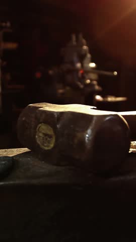 Mid-section of blacksmith holding hammer in workshop 4k