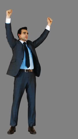Handsome businessman with arms up on grey background